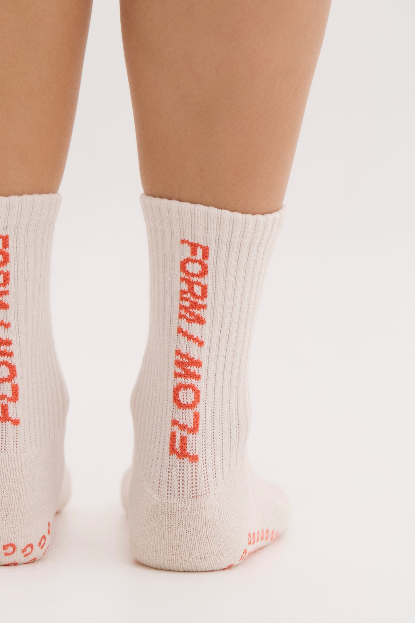 
                  
                    cream crew pilates socks with red text for stability
                  
                